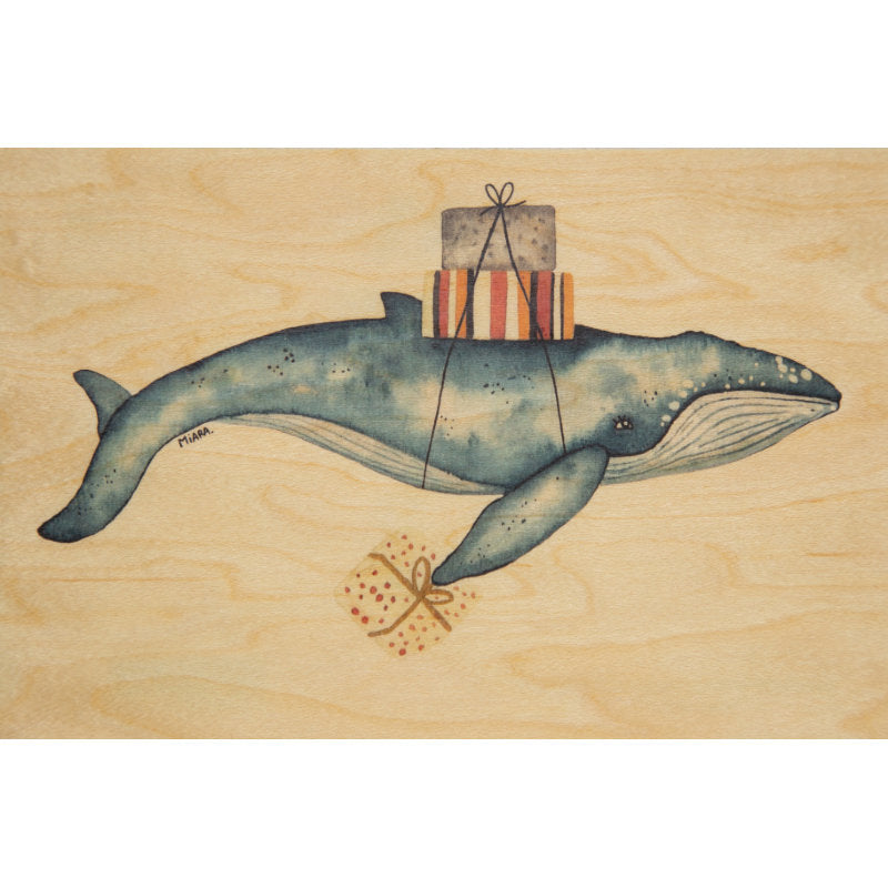 Carte en bois avec un dessin d'une baleine qui porte des cadeaux sur son dos.