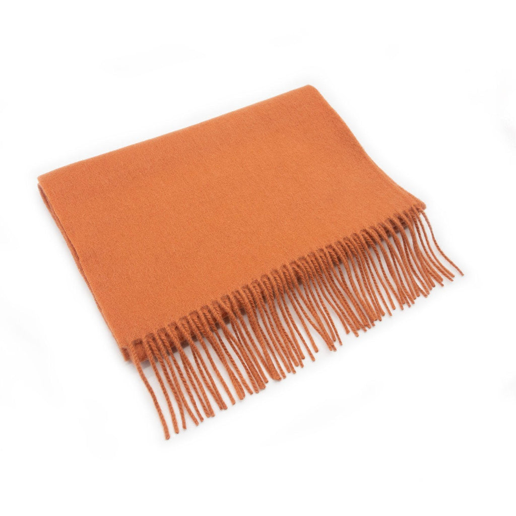Photo d'une écharpe en laine avec des franges de couleur abricot.