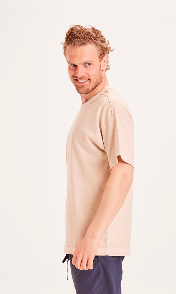 Photo d'un mannequin de profil portant un t-shirt en coton bio beige fabriqué en Turquie.