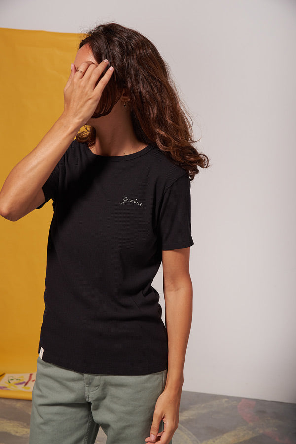Photo d'un mannequin portant un t shirt cotele brodé noir en coton bio et polyester recyclé fabriqué au Portugal.