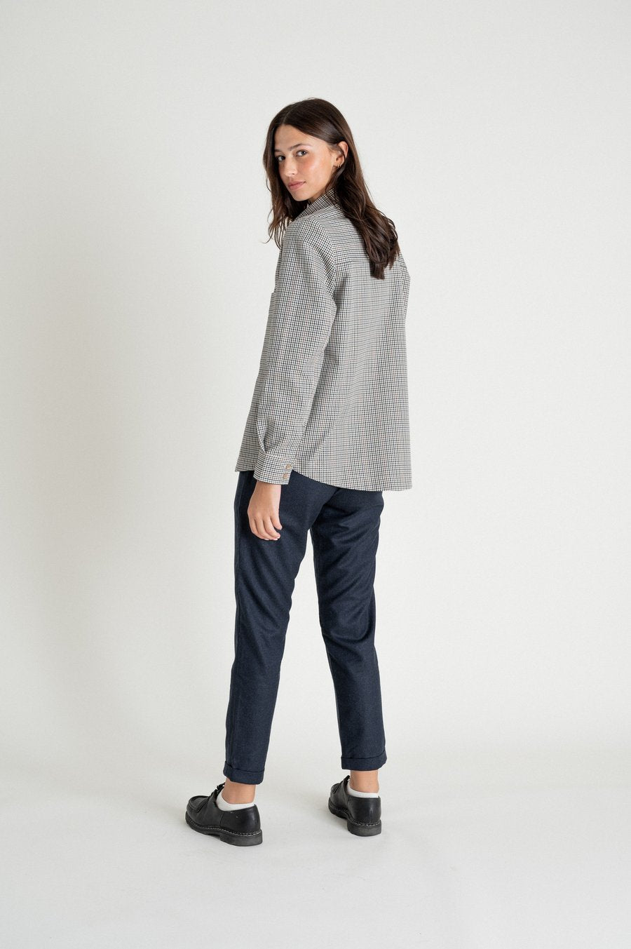 Une femme de dos porte une chemise à carreaux de la marque Noyoco.