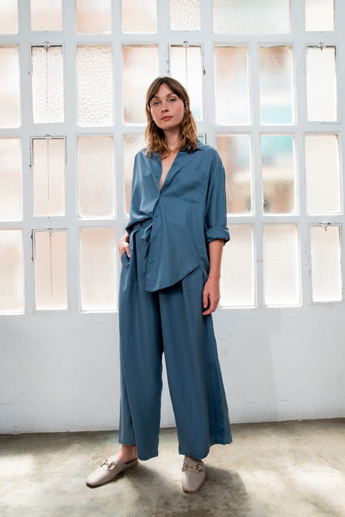 Photo d'un mannequin de dos portant une chemise lyocell femme bleue oversize fabriquée au Portugal de la marque Cossac.